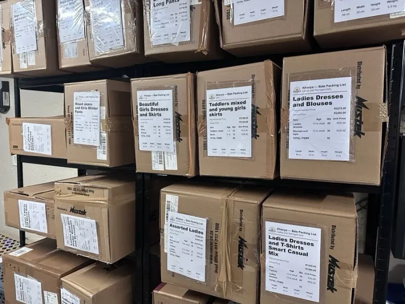Khanya warehouse shelves stacked with labelled clothing bales ready for delivery